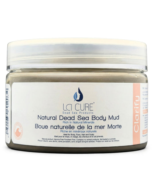A jar of LA CURE Natural Dead Sea Body Mud, featuring a white label with blue and peach text, set against a plain white background.