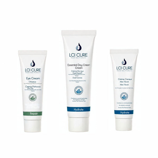 Three white cosmetic tubes from LCI CURE skincare arranged side by side on a white background, labeled Eye Cream, Essential Day Cream, and Crème Corsette.