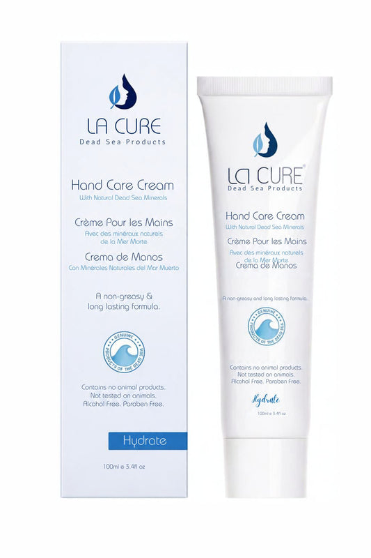 La Cure Dead Sea Products Hand Care Cream shown as a white squeeze tube next to its matching white and blue packaging box on a plain white background.